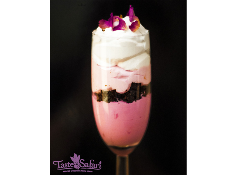 Layered ombre pink rose mousse with brownie in a tall glass