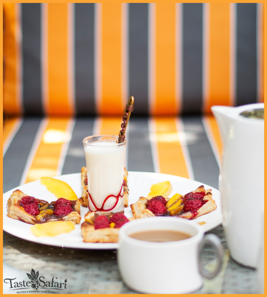 Raspberry, mango and coconut puff pastry slices served with tea and coconut milk