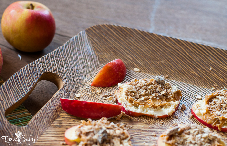 Apple slices topped with cream cheese, peanut butter and muesli